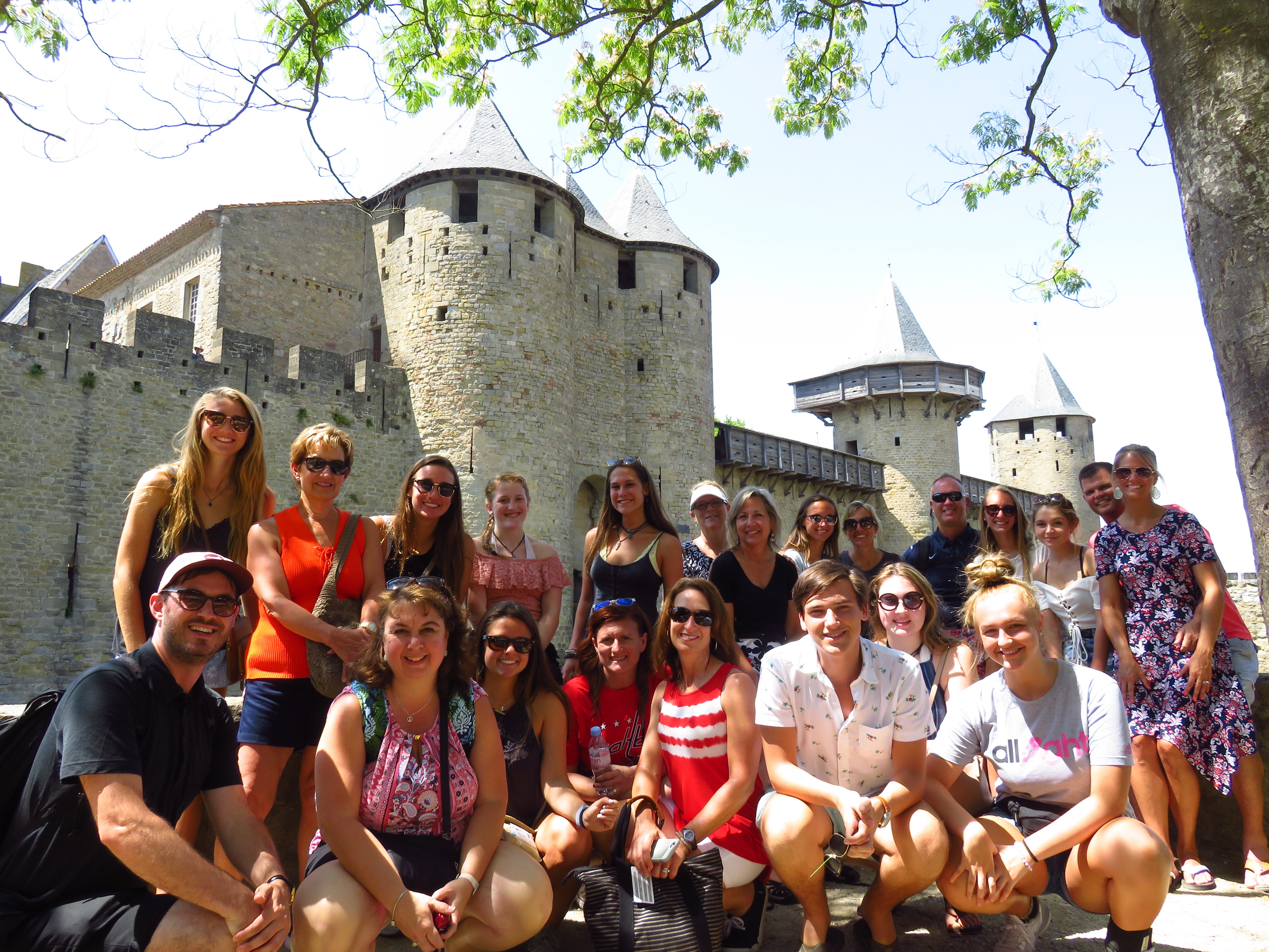 Group of students at the foot of Carcassonne ramparts 