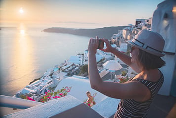 Student taking a picture in Santorini