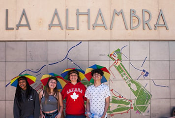 Students wearing funny hats at the entrance of the Alhambra