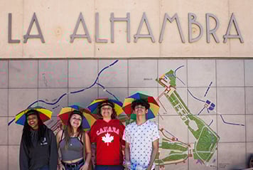 Students wearing funny hats at the entrance of the Alhambra