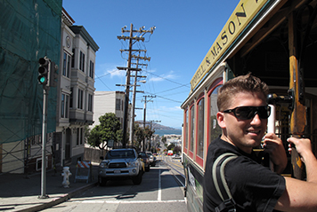 Student hopping on a trolley in San Francisco