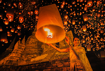 Lighting up a lantern in Thailand