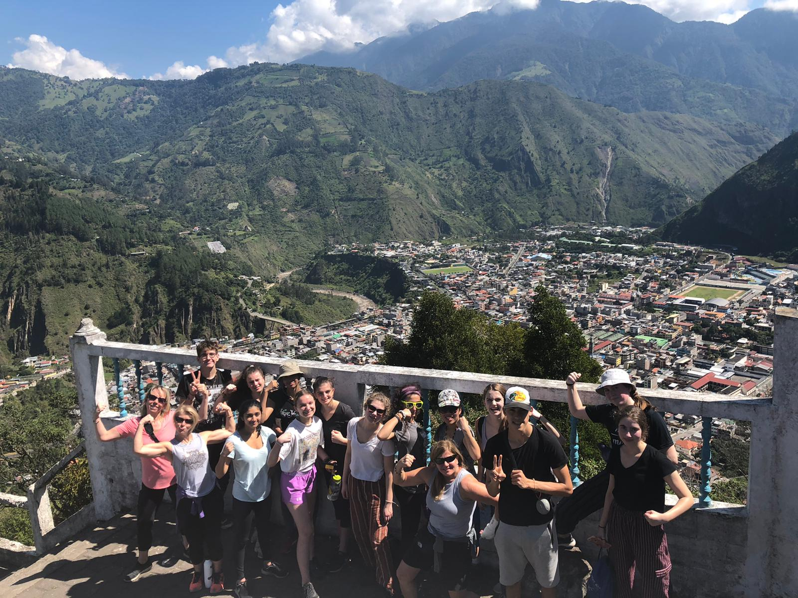 Students smiling at the camera from a viewpoint in Ecuador