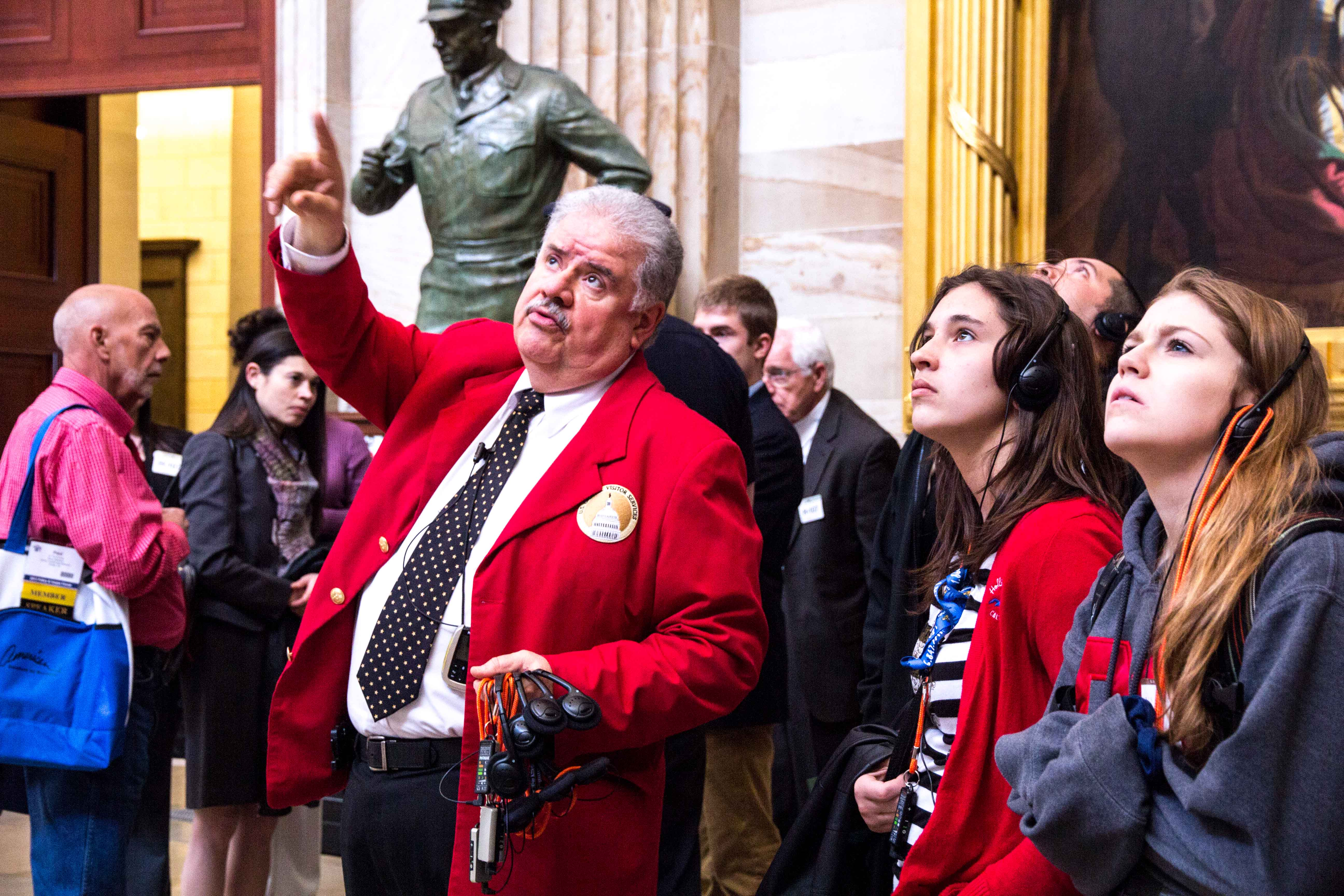 Employee from the U.S. Capitol points out artwork to students on tour