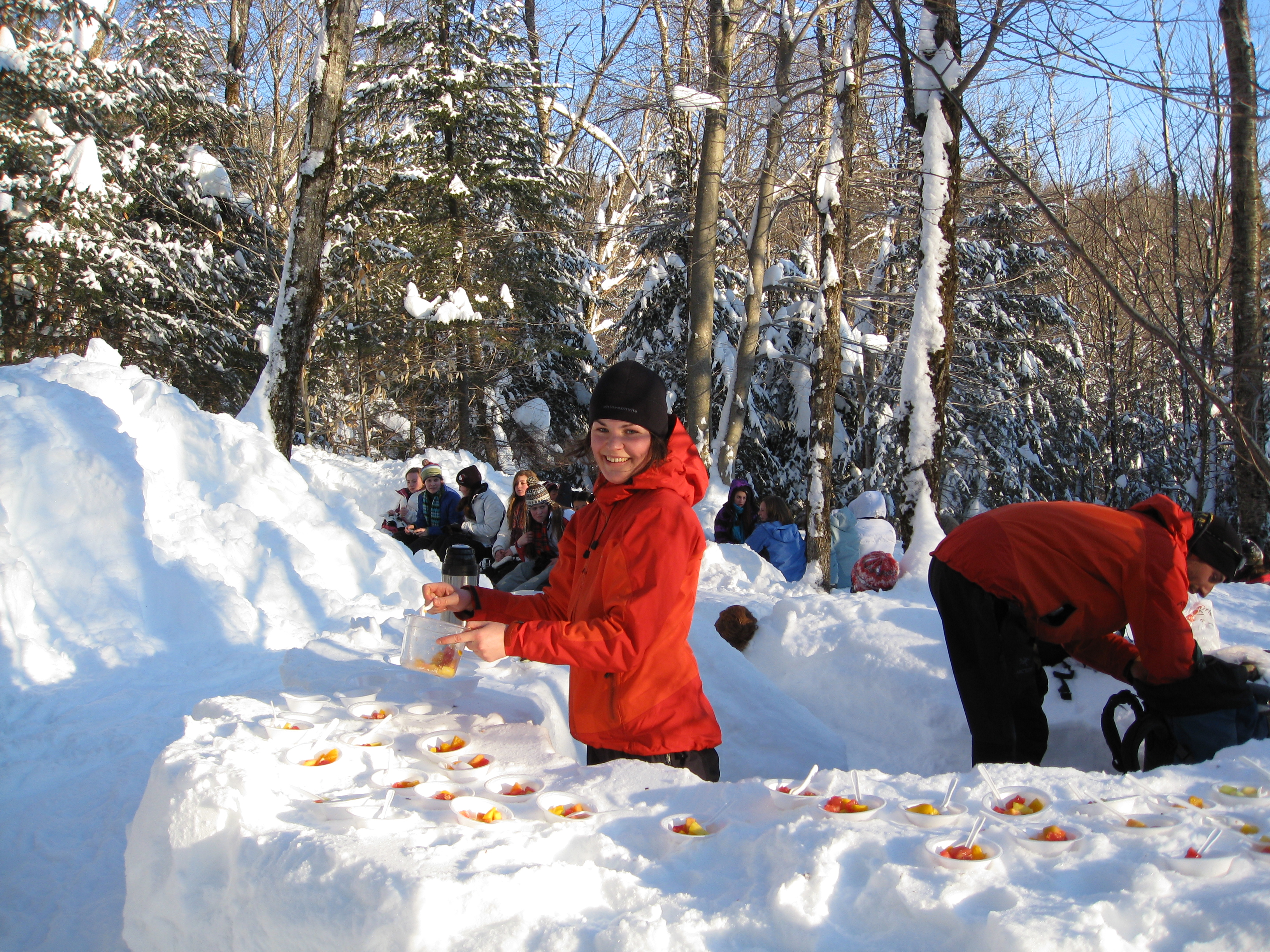 Host preparing maple taffy after the snowshoe excursion.