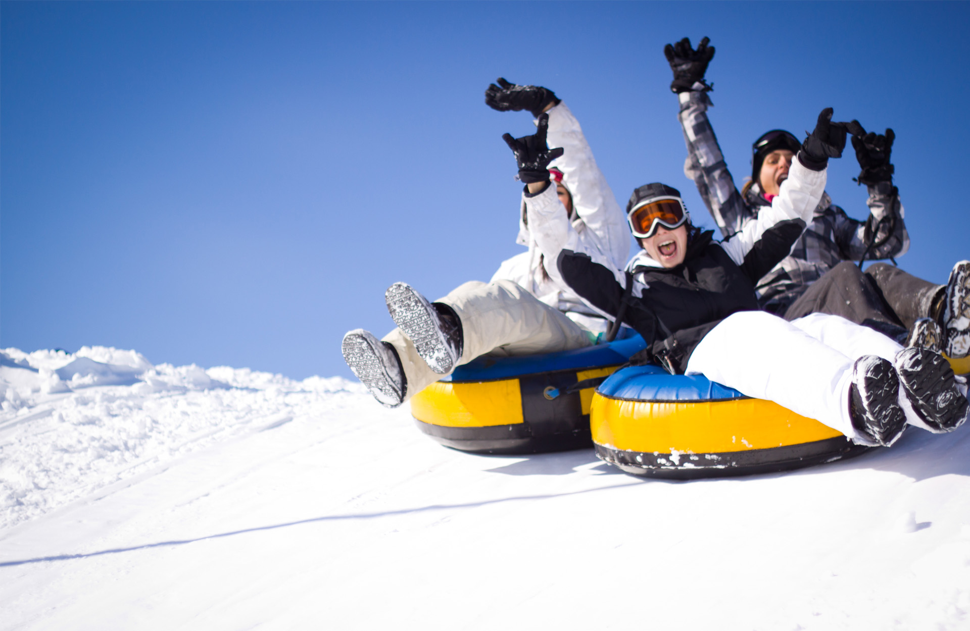 Students tubing down the snowy slopes at Valcartier, Quebec